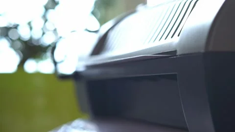 Close-up of a laminated white sheet of paper coming out of the laminator Stock Footage 152201631