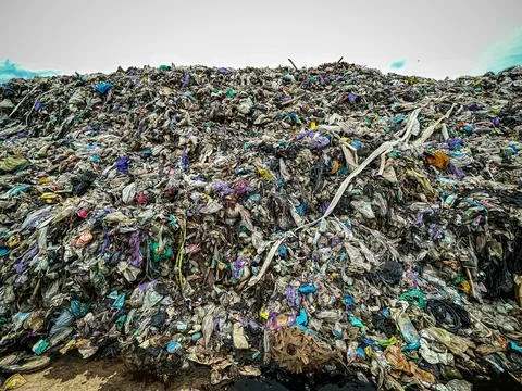 Close-up landfill garbage wall compacted plastic waste environmental Stock Photos