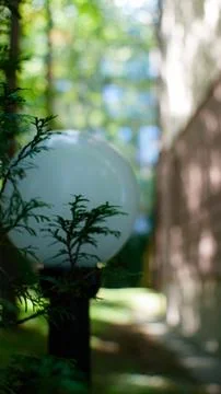 Close-up of a lantern in the park against the background of buildings. Stock Photos