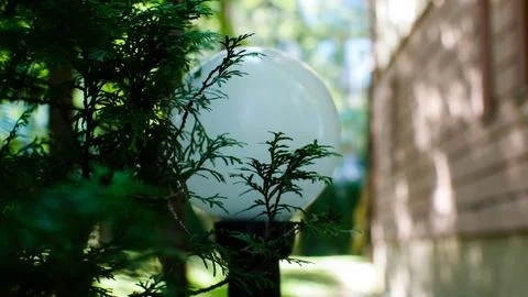Close-up of a lantern in the park against the background of buildings. Stock Photos