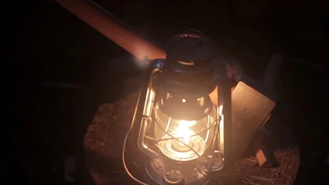 Close up of a lanterns and axe panning to a small fire Stock Footage 103365032