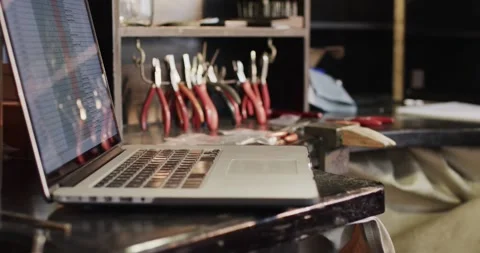 Close up of laptop and handcraft tools in studio in slow motion Stock Footage 335268588