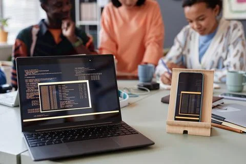 Close up of laptop and smartphone with programming code lines on screen 스톡 사진