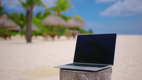 Close-up laptop on the background of the turquoise ocean on white sand Stock Footage 170406684