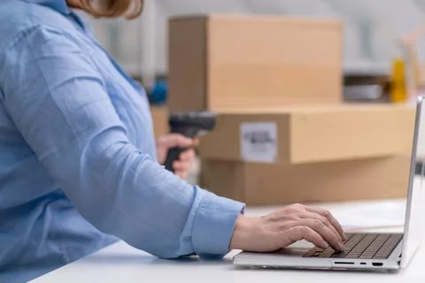 Close up laptop checking orders scanning barcode on packages for shipping Stock Photos