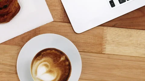 Close-up of laptop with coffee cup and sweet cookie Stock Footage 301037277
