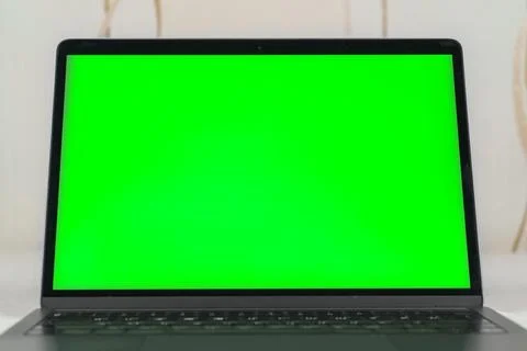 Close up of a laptop computer with chroma key monitor Stock Photos