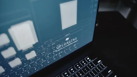 Close up on laptop computer screen uploading top secret documents to server Stock Footage 311538131