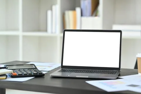Close up laptop computer with white screen, calculator and financial documents Stock Photos