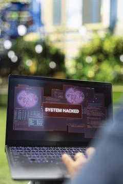 Close up of laptop displaying red system hacked alert over security windows Stock Photos