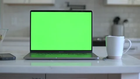 Close-up of laptop with green screen in kitchen Stock Footage 320089621
