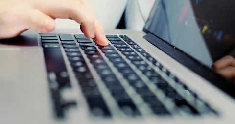 Close-up on laptop keyboard with backlit keys, boy's fingers press on keyboard Stock Footage 262225218