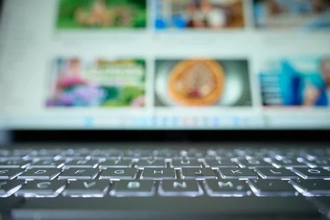 Close up of laptop keyboard with blurred screen in background Stock Photos
