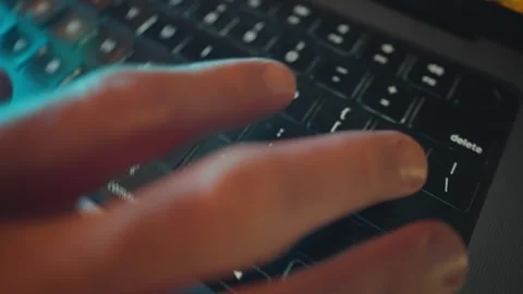 Close up on laptop keyboard as man clicks the Return or Enter key on keyboard Stock Footage 341875117