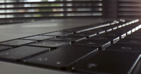 Close-up of a Laptop Keyboard Showcasing Reflections and Shadows Stock Footage 337845482