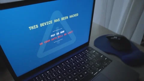 Close up on laptop - message pops requesting ransom payment in exchange for data Video stock 342512285