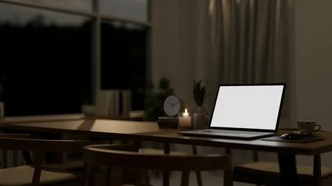 A close-up of a laptop mockup on a dining table in a contemporary dining ro.. Stock Photos