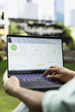 Close-up of laptop screen displaying solar energy metrics and system data Stock Photos
