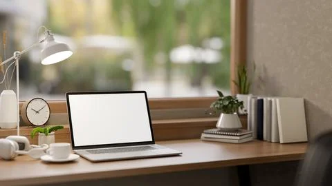 A close-up of a laptop with a white screen mockup and minimalist decor on a.. Stock Illustration