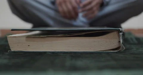 Close up of a large book being picked up by a man Stock Footage 154657868