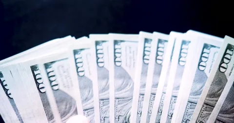 Close-up of a large bundle of hundred dollar bills in the hands - view from eyes Stock Footage 201446917