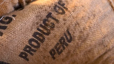 Close-up of a large burlap bag of cacao chocolate beans from Peru. Stock Footage 100646357