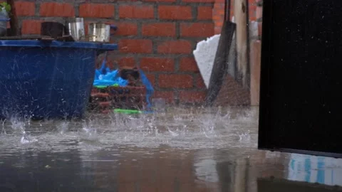 Close-up of large drops of intense rain falling on the floor of a roof of a 動画素材 164619723