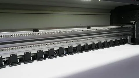 A close up of a large format inkjet printer in operation. Stock Photos