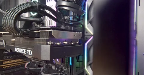 Close-up of large GPU inside high tech computer build with RGB fans. RTX Stock Footage 152358299