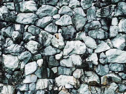 Close up large gray stone wall texture background natural material. Stock Photos