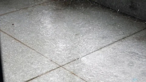 Close-up, large, heavy drops of rain fall with a spray. Water splashes on the Stock Footage 119502891