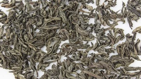 Close-up of large leaf black tea on a white background. Dried black tea leave Stock Photos