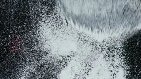 Close-up large makeup brush spreads facial powder dust onto a transparent Stock Footage 261186137