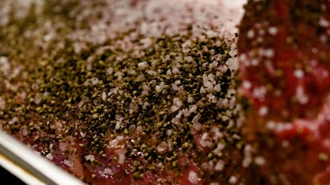 Close-up of a large piece of beef. Cook marinating meat with salt and pepper Stock Footage 264310034