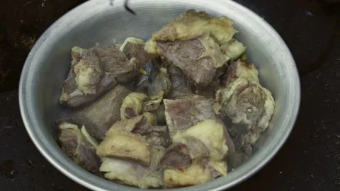 Close-up of large pieces of boiled meat for pilaf in aluminum bowl Stock Footage 332984357