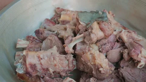 Close-up of large pieces of boiled meat for pilaf in aluminum bowl Stock Footage 346745716