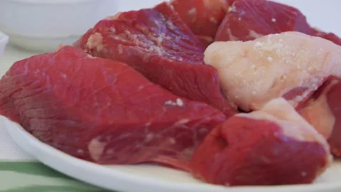 Close-up of large raw meat pieces for pilaf on a plate Video stock 333029943