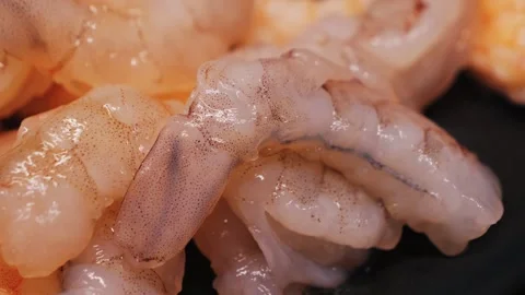 A close-up of large, raw, peeled shrimp, a source of high-quality protein. Stock Footage 334836388
