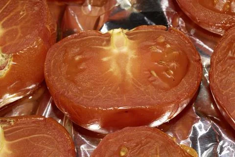 Close up of large red roasted tomatoes just cooked Stock Photos