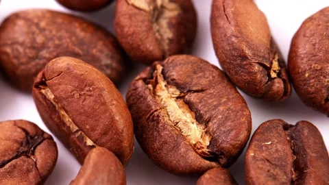Close-up of large roasted coffee beans, slow rotation 4k. Natural background Stock Footage 158109764
