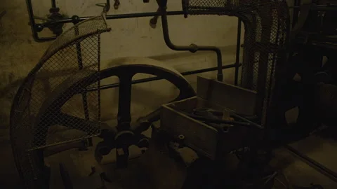 A close-up of a large, rusty metal gear and tool boxes in an industrial settings Stock Footage 301153023