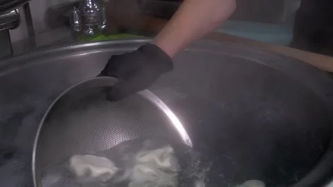 Close-up of large slotted spoon with cooked khinkali Stock Footage 267287586