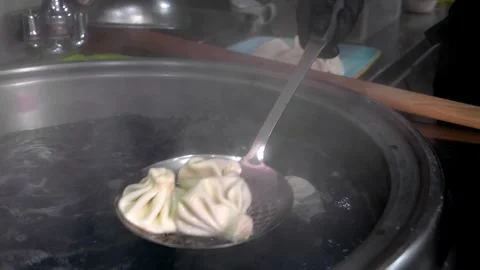 Close-up of large slotted spoon with cooked khinkali Stock Footage 267298226