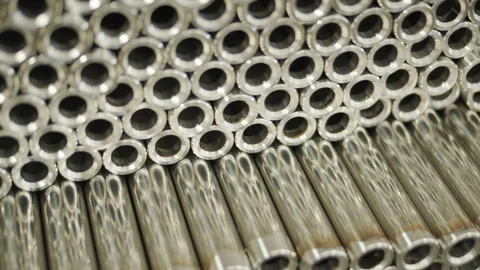 Close-up of a large stack of shiny, polished stainless steel metal tubes Stock Footage 345894133