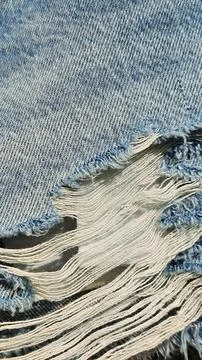 Close-up of a large torn hole in jeans Stock Photos