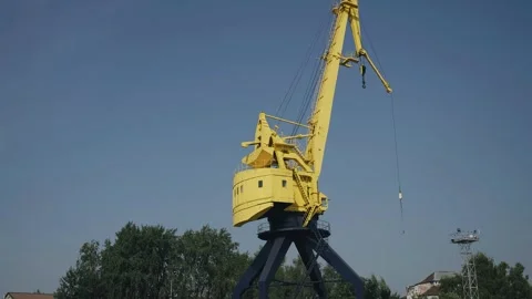 Close-up of a large yellow loading crane at the docks Stock Footage 252204034