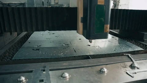 Close up of laser cutting machine shaping metal sheet with sparks in factory 库存影片 340607547