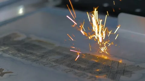 Close up: laser engraving machine burns logo on sheet of metal Stock Footage 329944318