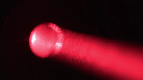 Close-Up of Laser Pointer Shooting Red Light Particles Beam Stock Footage 267055709