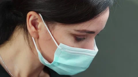 Close-up of the lash Maker wearing a protective medical mask during Stock Footage 140713005